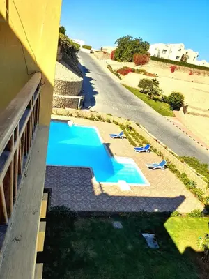 an overhead view of a swimming pool next to a building at استديو ايجار في الغردقه 206 in Hurghada