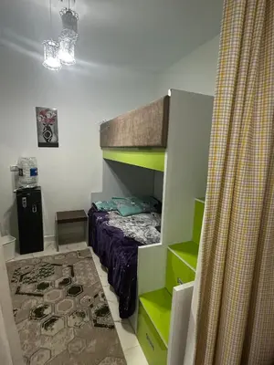 a small bedroom with a bunk bed and a rug at 2 bedroom apartment in Prestige Plaza in Hurghada