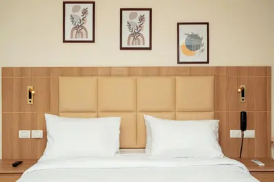 a bedroom with a large bed with four pictures on the wall at Shepherd I Dahabya in Esna