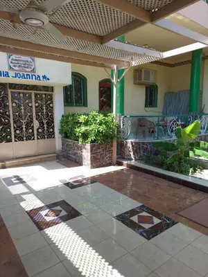 a house with a tile floor and a patio at Villa Joanna in Luxor