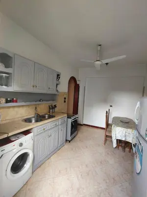 a kitchen with a sink and a washing machine at Villa Joanna in Luxor
