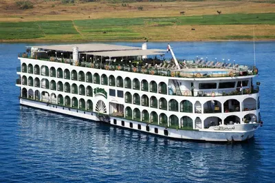 a large white cruise ship on the water at Five-Stars Deluxe River Kruz from Aswan to Luxor 3 Nights in Aswān