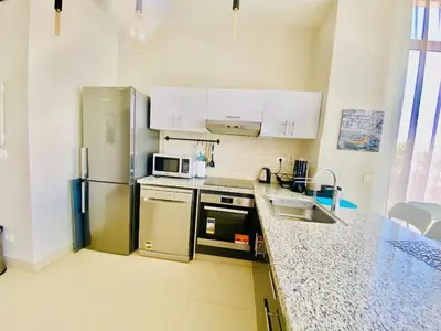 a kitchen with a stainless steel refrigerator and a sink at Luxury villa twaila in Hurghada