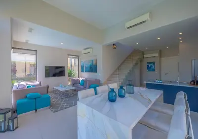 a living room with a large marble table and chairs at Airy & Bright 4BR Villa in Tawila, El Gouna, Private Pool & Lagoon Access in Hurghada