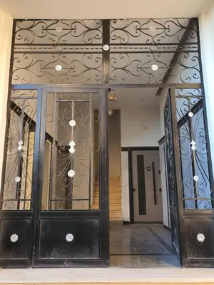 an entrance to a building with a wrought iron door at شقة صغيرة جميلة امام مارينا الغردقة in Hurghada