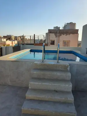 a set of stairs leading to a swimming pool at شقة صغيرة جميلة امام مارينا الغردقة in Hurghada
