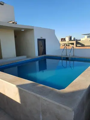 a swimming pool on the roof of a building at شقة صغيرة جميلة امام مارينا الغردقة in Hurghada