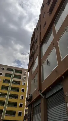 two tall buildings are next to each other at Diebo in Aswan