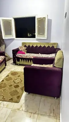 a living room with a purple couch and a window at Diebo in Aswan