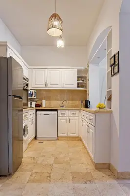a kitchen with white cabinets and a dishwasher at VESTA - El Gouna Residence in Hurghada