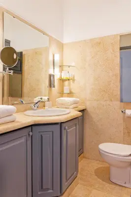 a bathroom with a sink and a toilet and a mirror at VESTA - El Gouna Residence in Hurghada