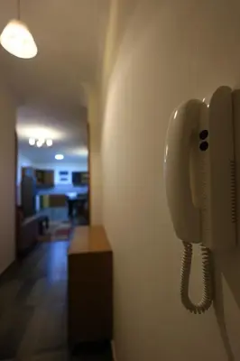 a phone is hanging on a wall in a hallway at Magawish Bliss , Elegant Hurghada Apartment in Hurghada