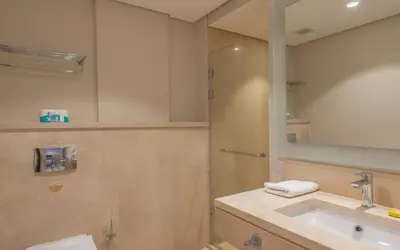 a bathroom with a sink and a shower with a mirror at New 1BR Apartment in Mangroovy El Gouna Pool, Beach, The Red Sea in Hurghada