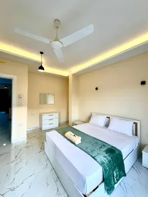 a large white bed in a room with marble floors at Royal Nile Villa - Luxury Nile Sky Penthouse 2 in Al Aqālitah