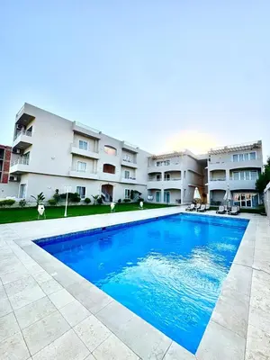 a large swimming pool in front of a building at Royal Nile Villa - Luxury Nile Sky Penthouse 2 in Al Aqālitah