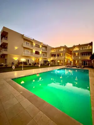a large swimming pool in front of a building at Royal Nile Villa - Luxury Nile Sky Penthouse 2 in Al Aqālitah