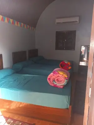 a bedroom with two beds with blankets on them at Nubian house in Jazīrat Salūjah