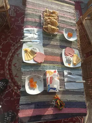 a table topped with plates of food and bread at Nubian house in Jazīrat Salūjah