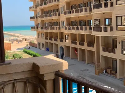 a view from a balcony of a building with the beach at One-Bedroom Chalet at Turtles Beach Resort , Pool & Side Sea View C22 in Hurghada