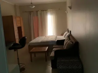 a room with a bed and a couch and a window at One-Bedroom Chalet at Turtles Beach Resort , Pool & Side Sea View C22 in Hurghada