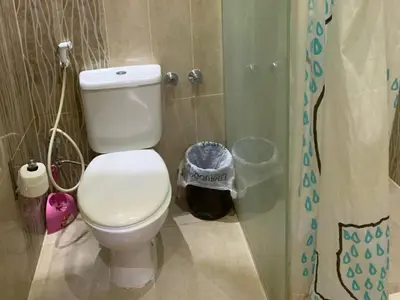 a bathroom with a white toilet and a shower at One-Bedroom Chalet with Side Sea View , Turtles Beach C23 in Hurghada