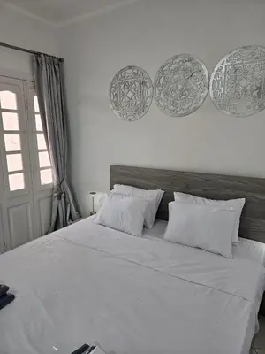 a bedroom with a large bed with white sheets and pillows at Simplestays Hurghada in Hurghada