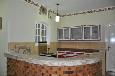 a kitchen with a brick island in the middle at White Villa in Luxor