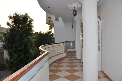 a hallway of a building with a checkerboard floor at White Villa in Luxor