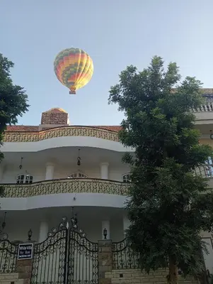 a hot air balloon flying over a building at White Villa in Luxor