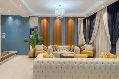 a living room with a white couch and a chandelier at Hurghada Sky Villa in Hurghada