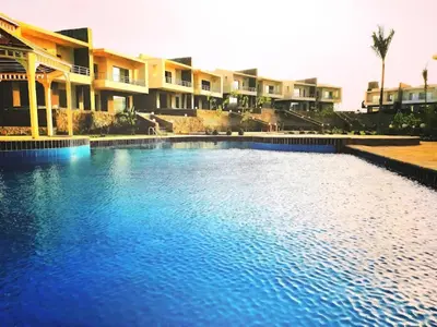 a large blue swimming pool in front of some apartments at Hurghada Sky Villa in Hurghada
