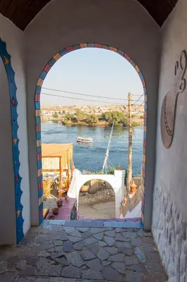 an archway in a building with a view of a river at Casa Nile View rooms - Nubian House -by kerma hospitality in Aswan
