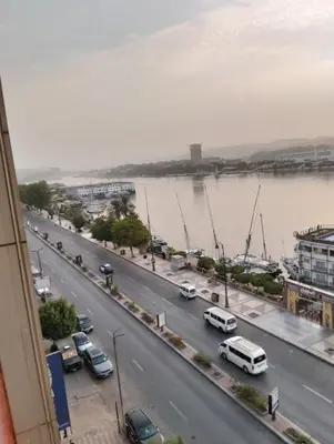 a view of a city street with cars and a river at اسوان مول بلازا in Aswān