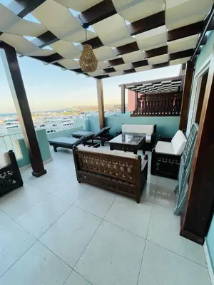 a balcony with furniture and a view of the city at New Marina Luxury Suite in Hurghada