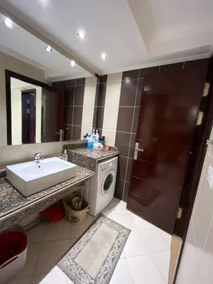 a bathroom with a sink and a washing machine at Cozy One bedroom old town tawaya Sahel hashish in Hurghada