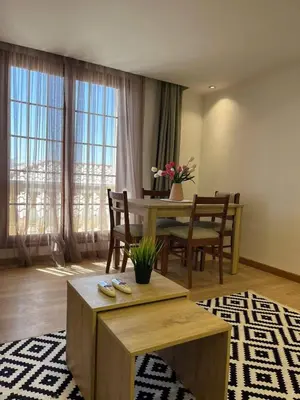 a living room with a table and chairs and a dining room at Cozy One bedroom old town tawaya Sahel hashish in Hurghada