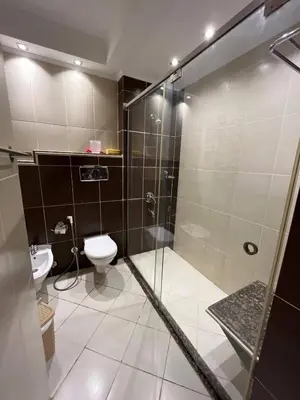 a bathroom with a shower and a toilet at Cozy One bedroom old town tawaya Sahel hashish in Hurghada