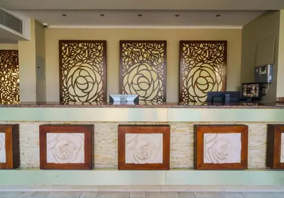 a lobby with gold and white art on the wall at Geisum beach hotel in Hurghada