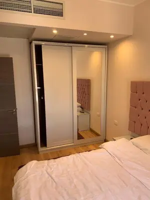 a bedroom with a bed and a large mirror at for the best all-rounder sea view Hurghada Apartment&DownTown AlDau in Banī Ghālib