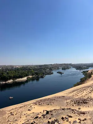 a view of a river from a sand hill at Aswan Holistic Hotel in Aswan
