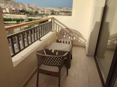 two chairs and a table on a balcony with a view at Aldau Heights Hurghada in Hurghada