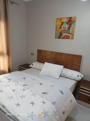 a bedroom with a bed with a comforter on it at Suncare America Resort - luxury rooms in Hurghada