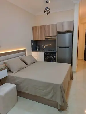 a bedroom with a large bed and a stainless steel refrigerator at Hurghada Sea view with pool in Hurghada