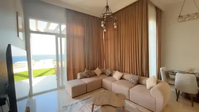 a living room with a couch and a table at Azzurra villa in Hurghada