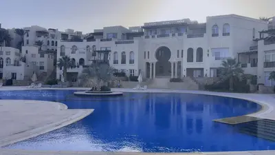 a pool in front of a large building at Azzurra villa in Hurghada