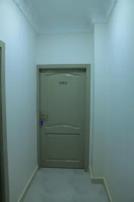 a door in a room with a white wall at Aswan City Star in Aswan