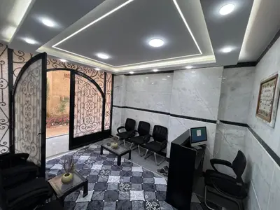 a room with a salon with chairs and a window at Aswan City Star in Aswan