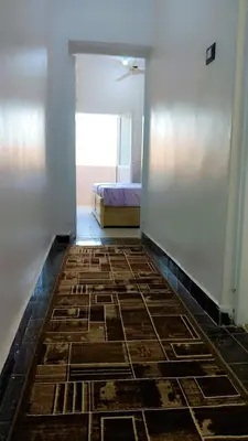 a room with a bedroom with a bed and a hallway at Atlas Aswan Apartment Near Nile Corniche and Old Tourist Market شقة أطلس أسوان بجوار كورنيش النيل والسوق السياحي القديم in Aswan