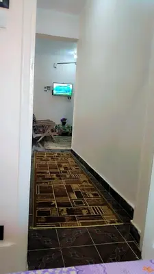 a hallway with a tile floor in a room at Atlas Aswan Apartment Near Nile Corniche and Old Tourist Market شقة أطلس أسوان بجوار كورنيش النيل والسوق السياحي القديم in Aswan
