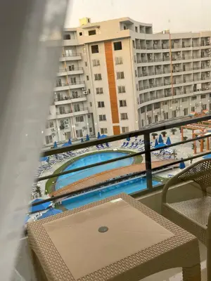 a balcony with a view of a pool and buildings at Tiba Golden Resort in Hurghada